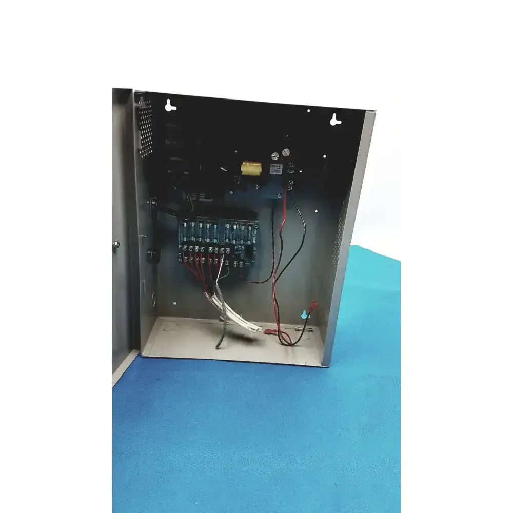 Metallic gray altronix smp7-ctx high current power supply with visible internal wiring and circuitry inside