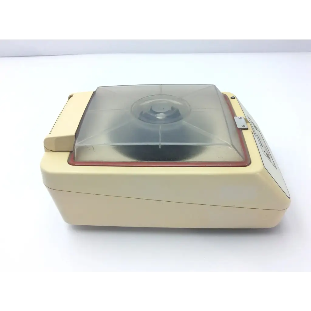 Cream-colored baxter stat 60 centrifuge with transparent lid and red trim designed for laboratory use model af5-31 12723sm