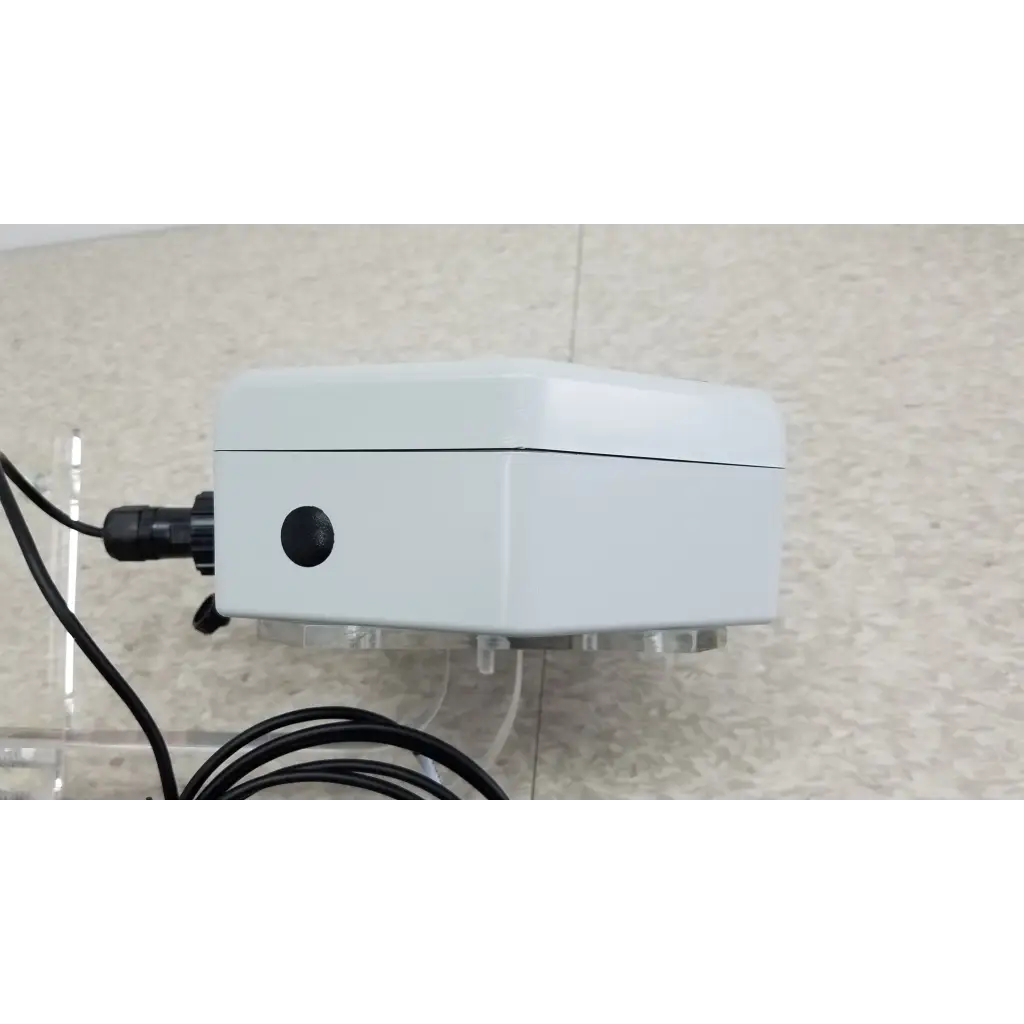 White rectangular ChemDAQ steri-trac 2 peracetic acid monitor with black circular port acrylic stand and cable