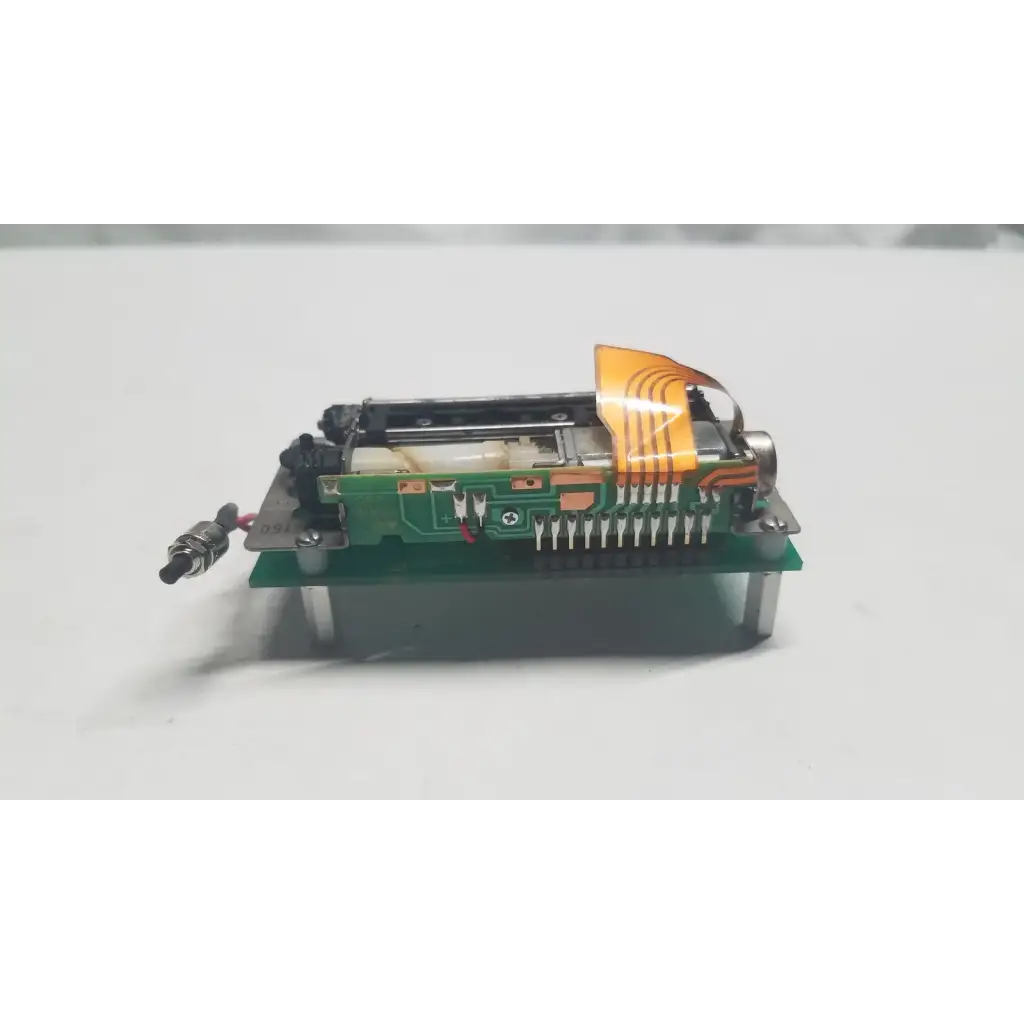 Green data synceng circuit board with orange flexible ribbon cable and metallic components featuring PIC16F628A chip
