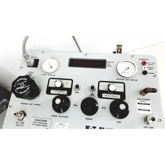 Silver metallic Eaton UPC5000 consolidated controls pressure calibration standard panel with black knobs gauges and labeled switches