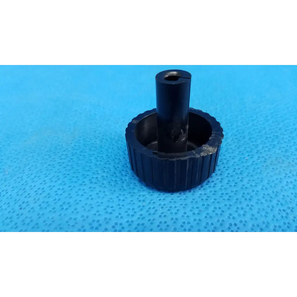 Black ribbed plastic adjustment knob with central hole for external control panel of topcon trc-nw8 retinal camera