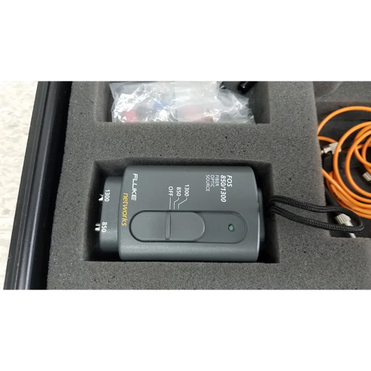 Gray fluke networks fos 850/1300 fiber optic source device with labeled wavelength settings and black lanyard