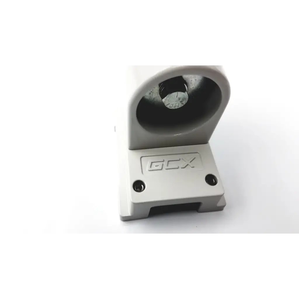 Gray plastic gcx wmm-0006-01 pivot arm mounting bracket with circular recess housing a metallic component