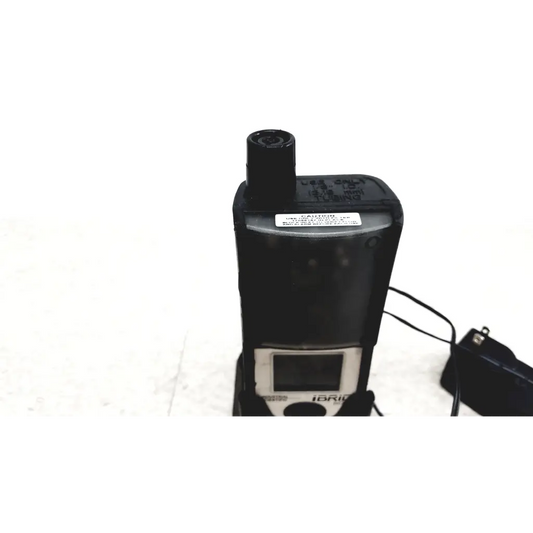 Black plastic industrial scientific ibrid mx6 multi gas monitor with small screen and cylindrical sensor on top with charger