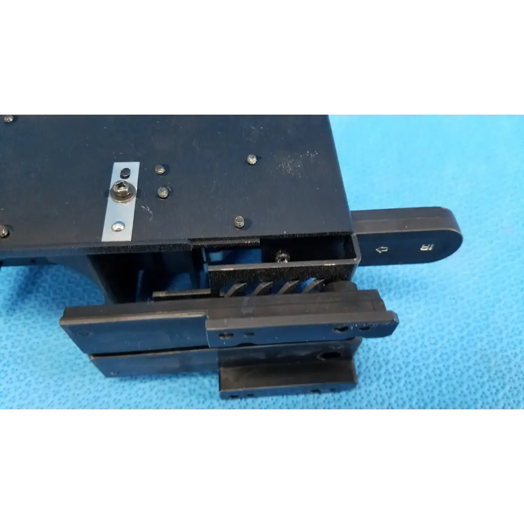 Black plastic mechanical drawer slide with metal hardware and handle for internal halogen illumination lamp assembly housing