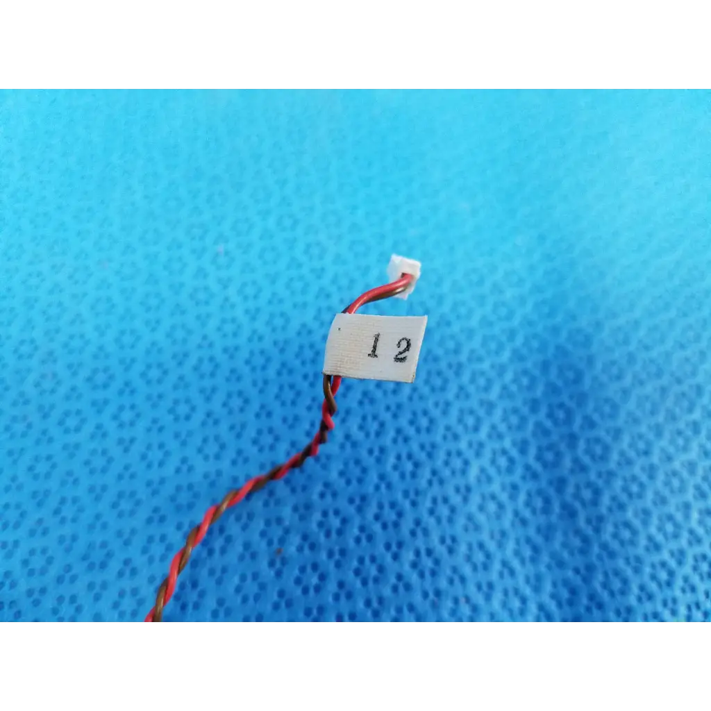 Red and black twisted wire with white connector and label 1 2 for internal mechanical limit sensor in topcon fundus camera
