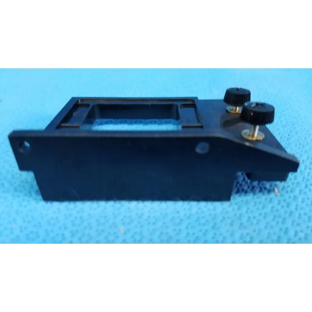 Black plastic internal optical alignment mirror mount slider bracket with two knurled adjustment knobs for topcon retinal camera