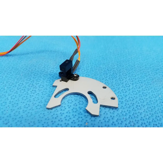 White plastic gear with black motor mount and multi-colored wiring on internal optical base axis limit sensor with aluminum bracket