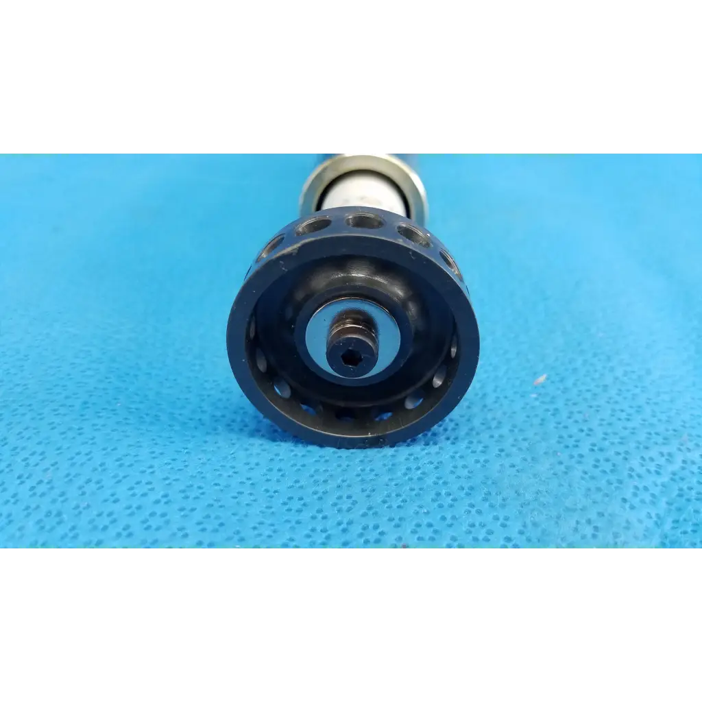 Black plastic optical core piston gear with circular cutouts mounted on metallic shaft for topcon trc-nw8 camera