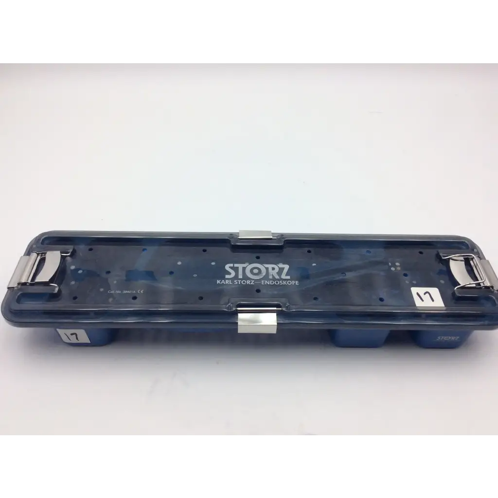 Dark blue translucent plastic karl storz flexible scope sterilization tray with silver metal latches and white label on lid