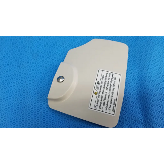 Beige plastic lamp house cover panel with silver screw and caution label for topcon trc-nw8 retinal camera