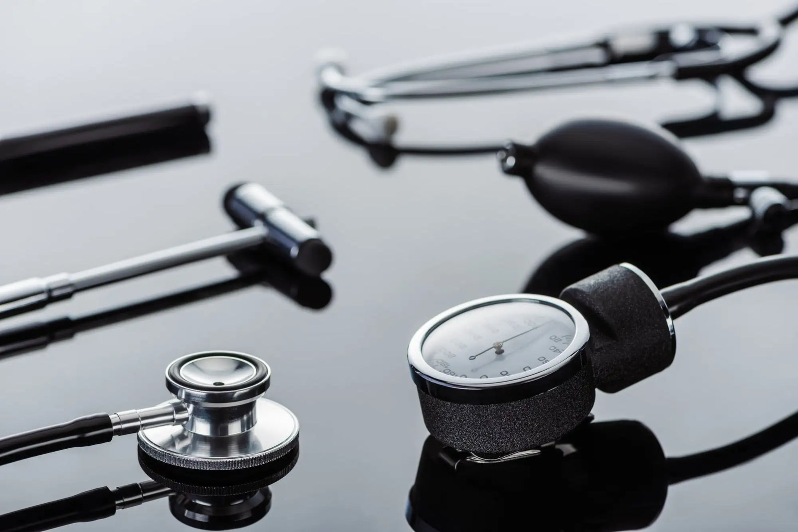 Silver and black stethoscope with a circular chest piece, metallic tubing, and an adjustable headband.