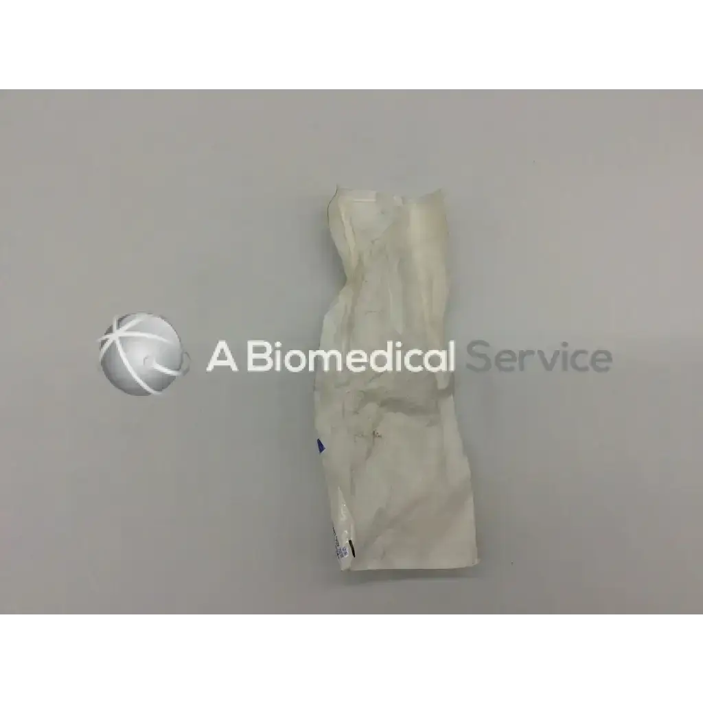 A crumpled white sterile medical glove next to sterrad chemical indicator 14100 lc-14100-004 rev for contamination detection