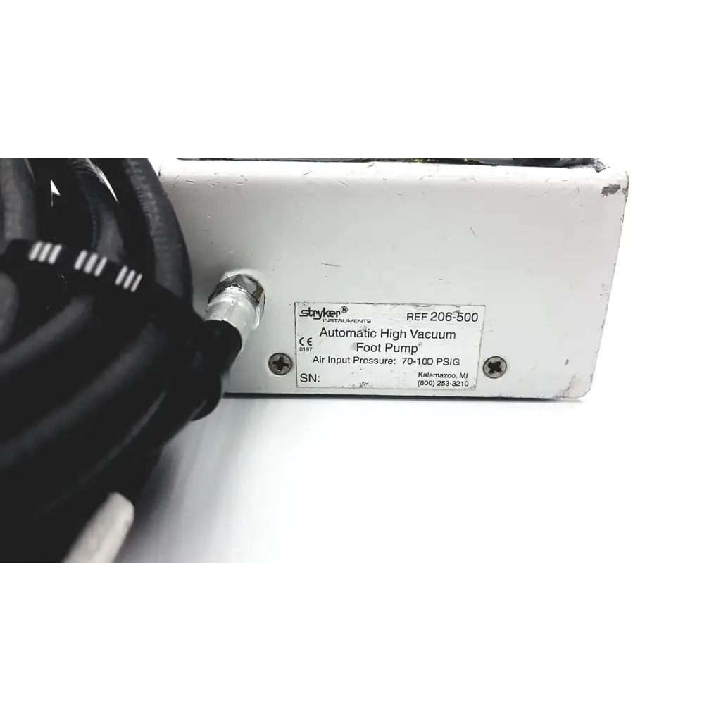 White metal Stryker 206-500 automatic high vacuum foot pump with black cables connected to the side for medical use