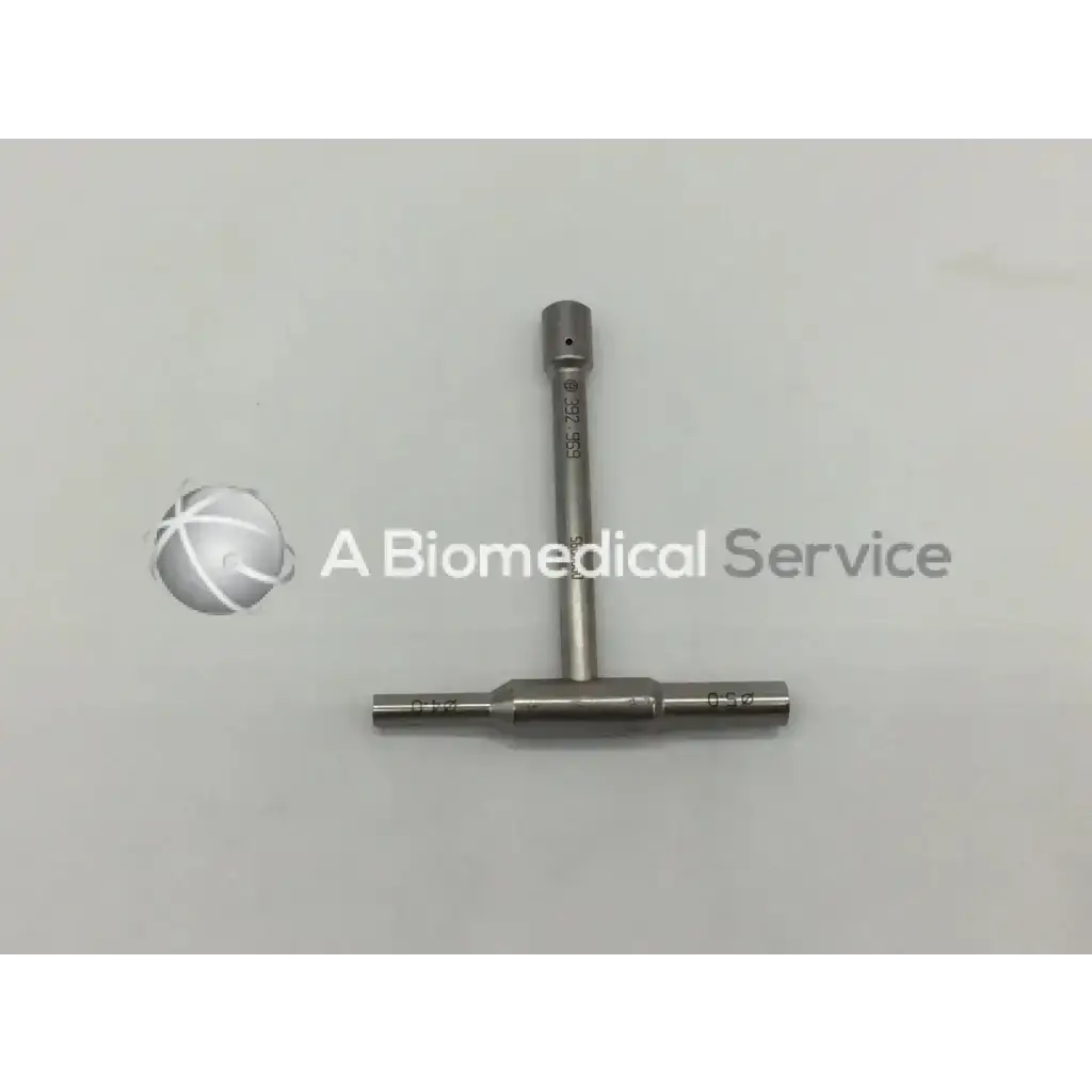 Silver metallic t-shaped synthes 392.969 combination wrench 4mm with engraved markings on shaft and crossbar