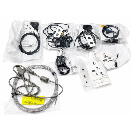 Gray coiled usb cable with yellow warning label and gray connector housing for procomp biofeedback device kit