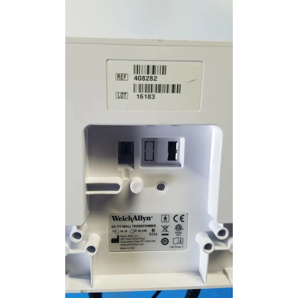 White plastic welch allyn gs 777 wall transformer with molded slots and label showing model and safety certifications