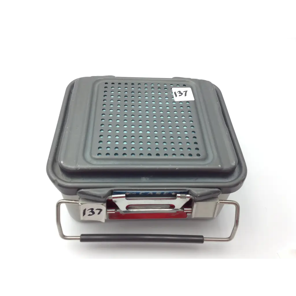 Gray plastic genesis case sterilization container with perforated lid and metal handle for case sterilization