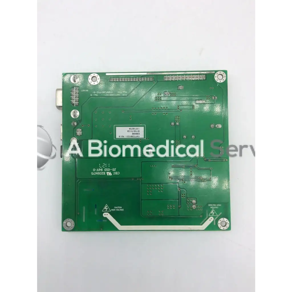 Green rectangular circuit board with silver solder points and slots for components tyco electronics e385256 rev B board