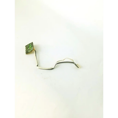 Green control board tf-12 with black and white ribbon cable attached showing electronic components and connections