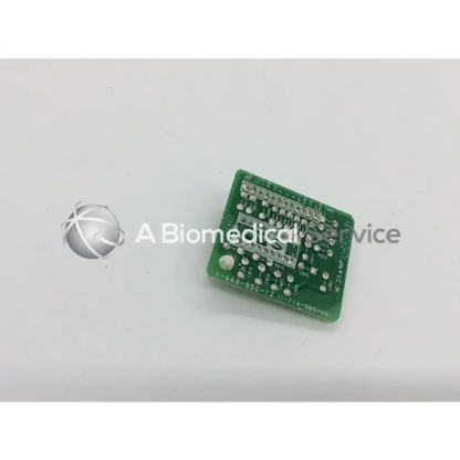 Green rectangular sony board with silver soldered components and white text for biomedical service and responsible electronics recycling