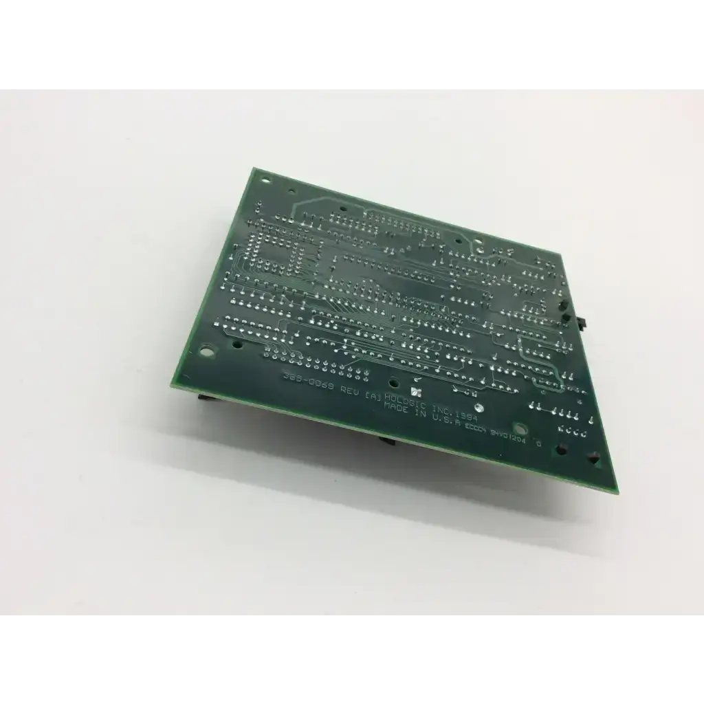 Green rectangular control panel board with intricate silver traces and mounting holes for hologic bone densitometer