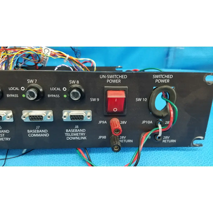 Black 19-inch rackmount control panel interface chassis with red power switch and labeled ports on front panel