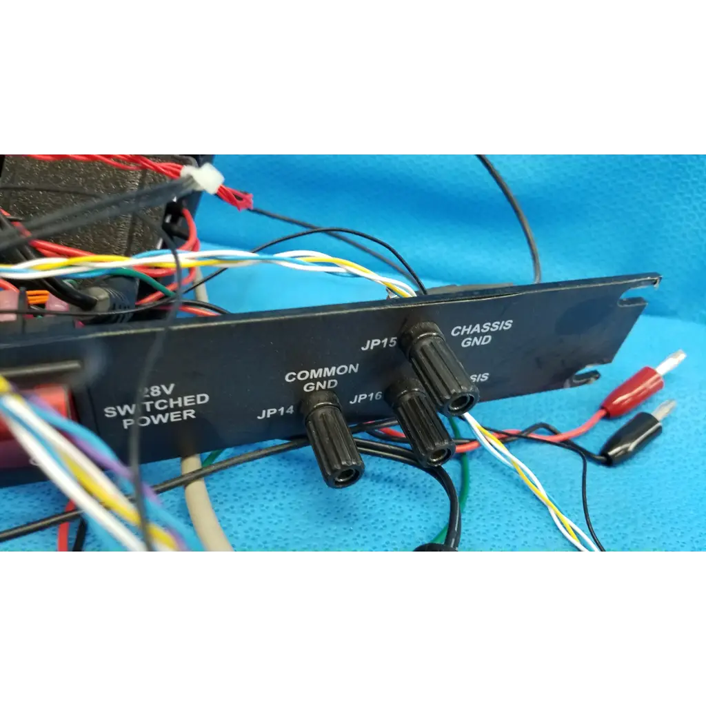 Black rectangular 19-inch rackmount control panel interface with labeled connectors and color-coded wires backside view