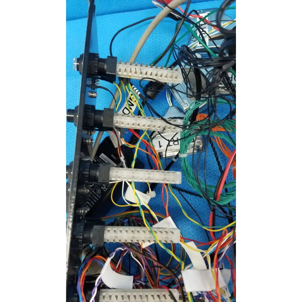 Black metal 19-inch rackmount control panel interface with white connectors black knobs and colorful wire harnesses