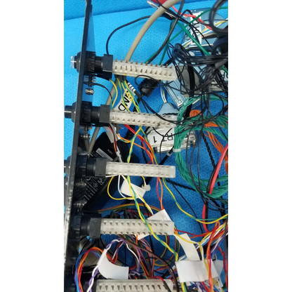 Black metal 19-inch rackmount control panel interface with white connectors black knobs and colorful wire harnesses