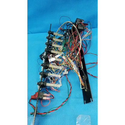 Black 19-inch rackmount control panel interface chassis with multiple connectors and colorful wire harness backside view