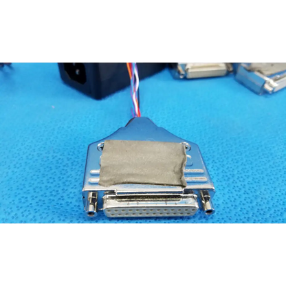 Silver metal d-sub connector with gray fabric patch and multicolored wires on 19-inch rackmount control panel interface