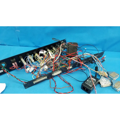 Black 19-inch rackmount control panel interface chassis with colorful wire harness cables on the back side