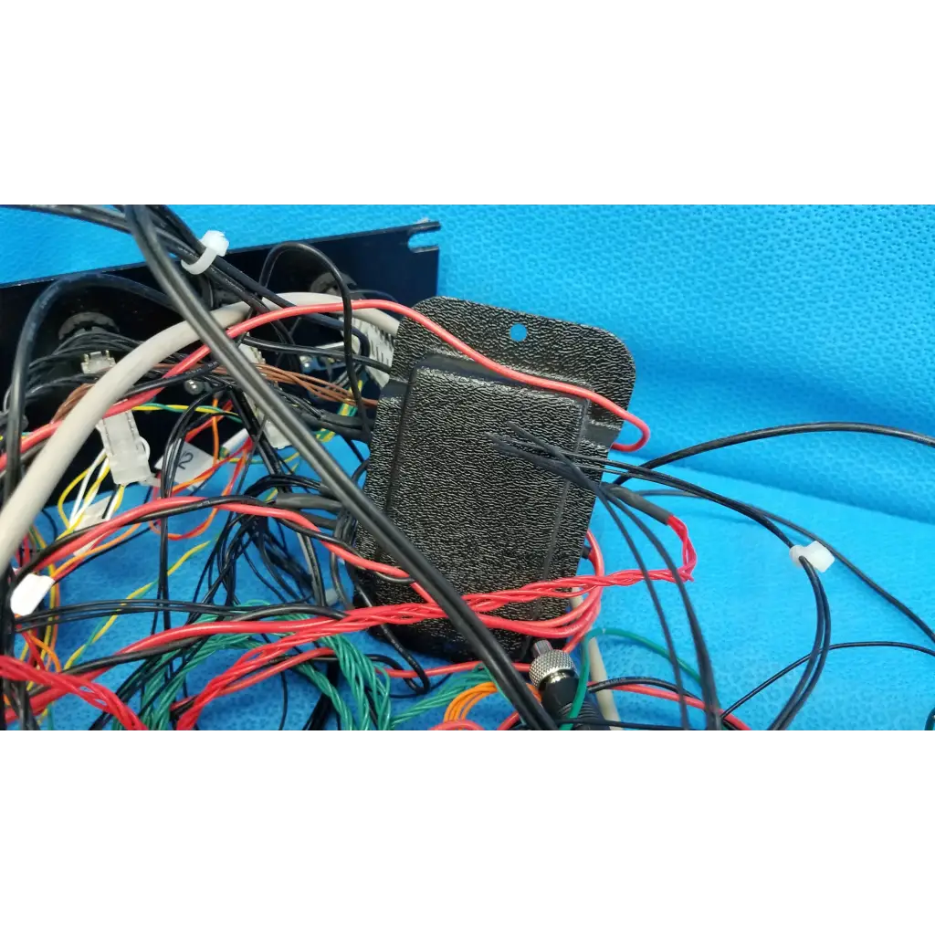 Black textured 19-inch rackmount control panel interface chassis with colorful wire harness for communications test signal switch