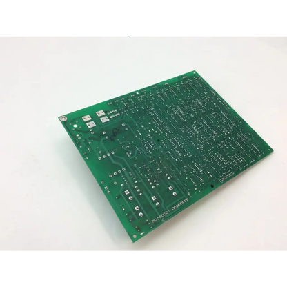 Green rectangular printed circuit board with silver solder pads and mounting holes for 1998 dental gendex 9000 xray control replacement part