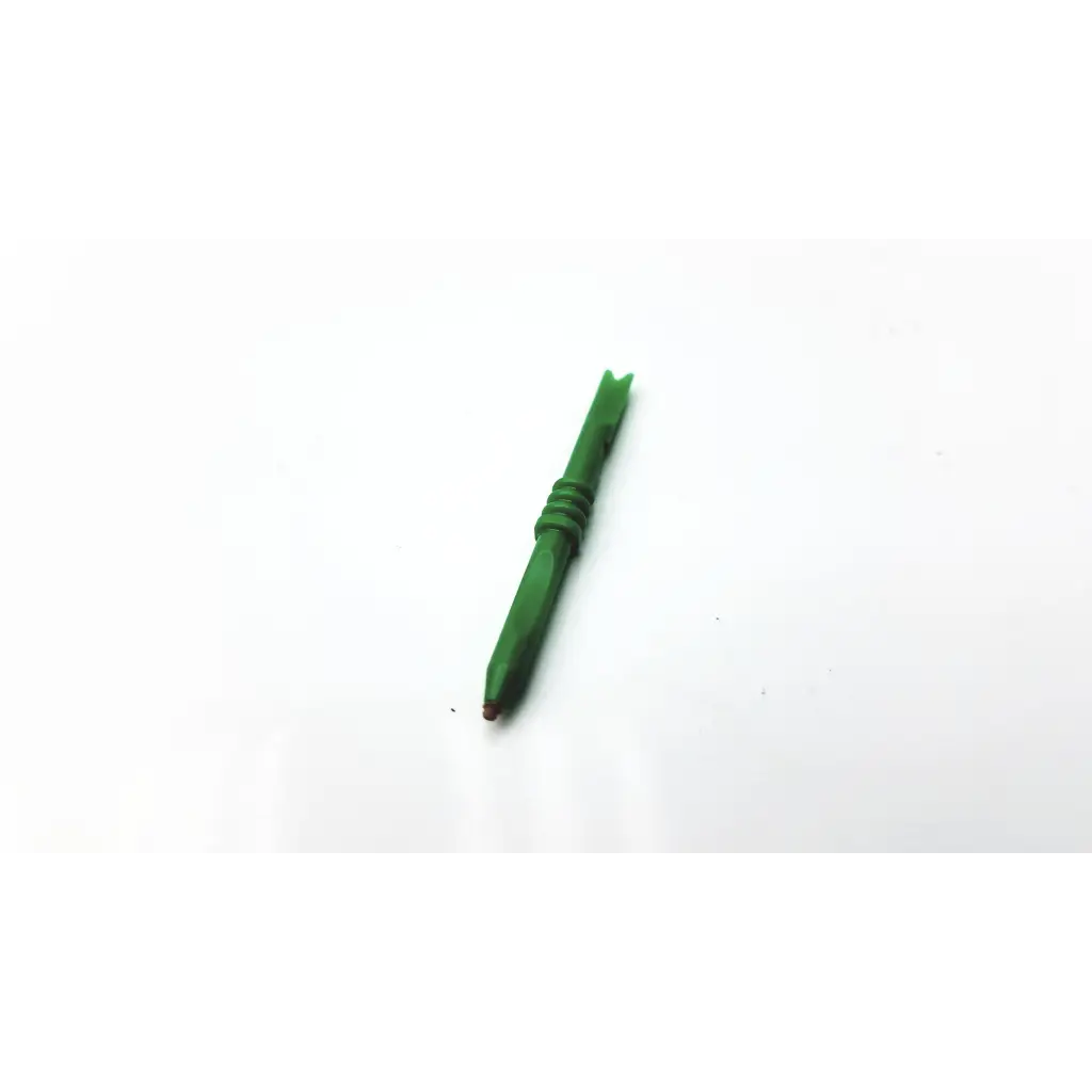 Green plastic dart flight with textured grip and pointed tip, shown with 32 count starkey custom hearing aid medium brown covers
