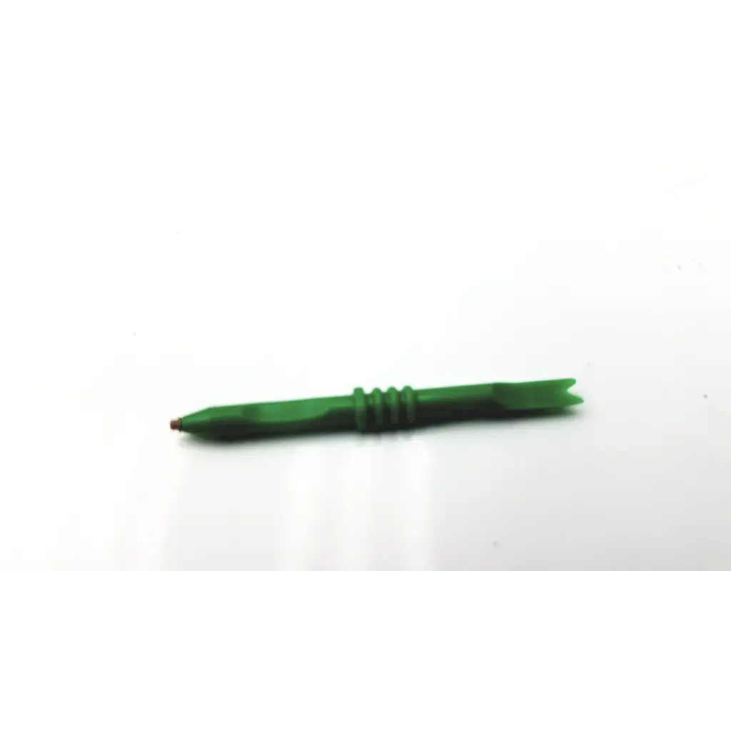 Green plastic arrow nock with three ridges and pointed tip shown with 32 count starkey custom hearing aid medium brown microphone covers