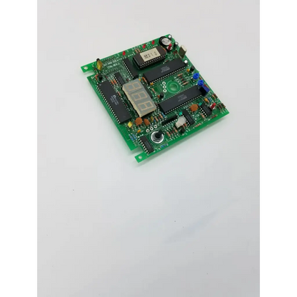 Green printed circuit rev j board with black integrated circuits digital display and various electronic components