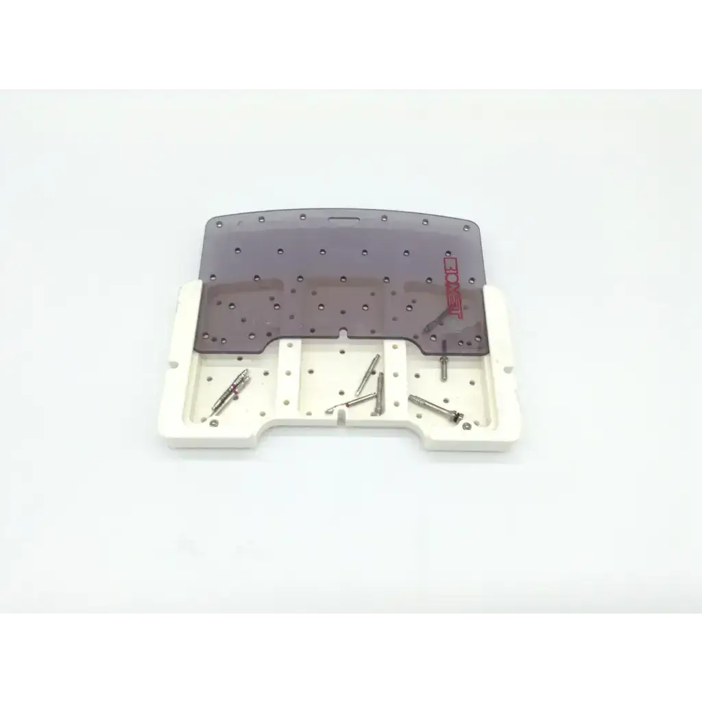 Gray translucent plastic dental surgical tray with white base holding metallic orthodontic brackets for tapered implant depth