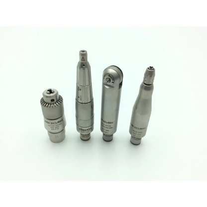 Four metallic microaire surgical instruments handpieces with engraved brand names in a surgical instruments drill set