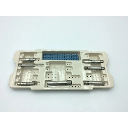 Beige plastic tray holding multiple metallic microaire surgical instruments with blue component in the center for drill set