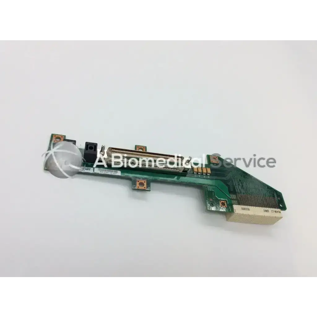 Green circuit board cisco slot backplane with black connectors and white circular component attached at one end