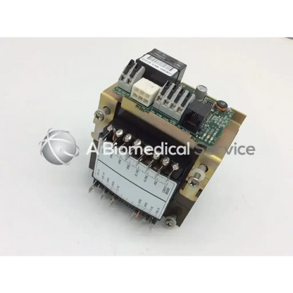 Gold-colored metal dental light relay module with green circuit board and white connectors for biomedical service use