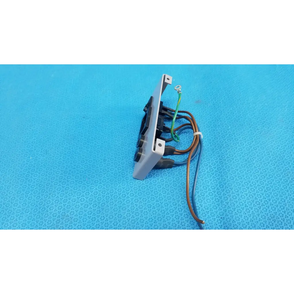 Back side of gray plastic ac power input plate assembly with switch fuse holder and multiple wires connected terminals