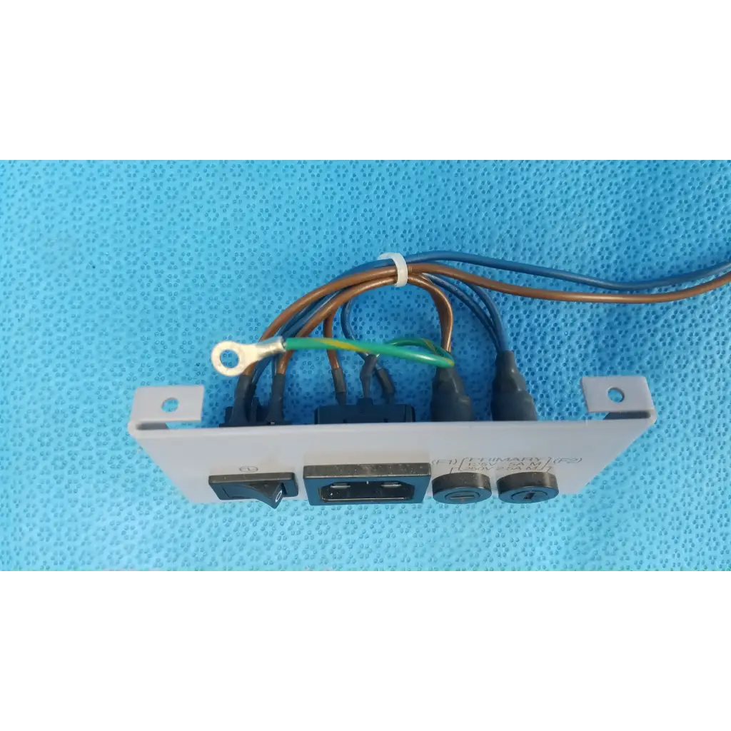 White plastic wall-mounted plate assembly with fuse holder switch usb port and power input sockets for retinal camera