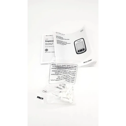 White accu-chek guide me blood glucose meter with black buttons and manuals for accurate glucose meter testing device use