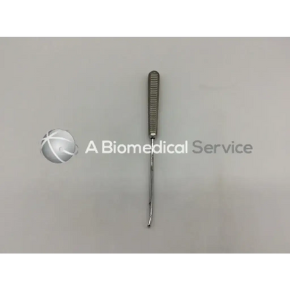 A sleek metallic curette ac5-236 121322sm with textured grip handle and slender curved tip for precision use
