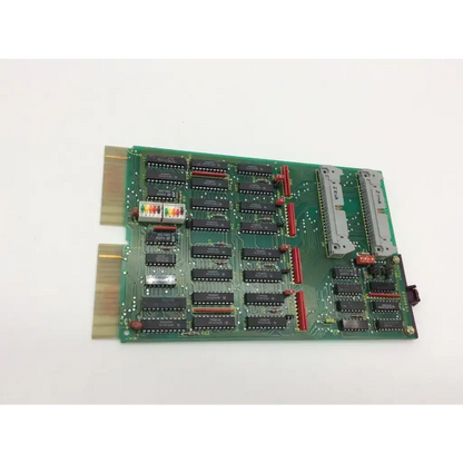 Green circuit board with black integrated circuits and red connectors for adac 1664attl output pulse board