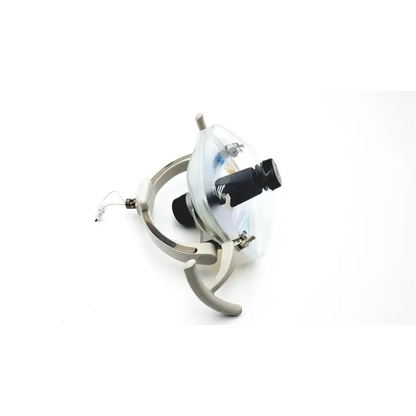 Silver-colored adec dental surgical exam operatory light with clear protective cover and black adjustment knobs
